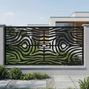 Metalowy panel ogrodzeniowy w czarnym kolorze z dynamicznym ażurowym wzorem falistych linii zamontowany między jasnymi słupkami przy nowoczesnym domu.