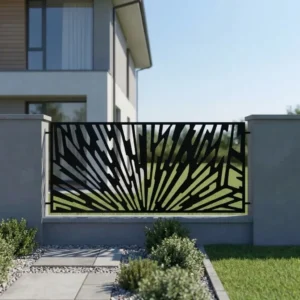 Metalowy panel ogrodzeniowy w czarnym kolorze z dynamicznym ażurowym wzorem promieni zamontowany między jasnymi słupkami przy nowoczesnej posesji.