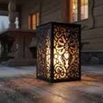 metalowy lampion z motywem serca i parzenicy w stylu góralskim, czarny z ciepłym światłem