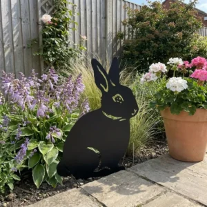Metalowa dekoracja ogrodowa do wbicia Ogrodowy Królik na rabacie obok kwiatów